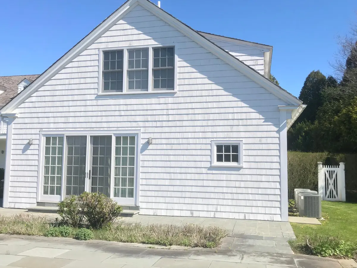 Freshly painted white colonial exterior with black shutters