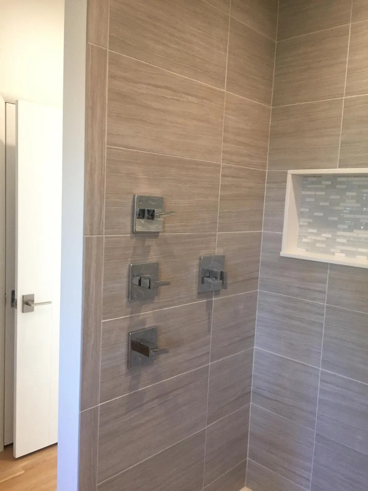 Bathroom shower tile with fixtures installed