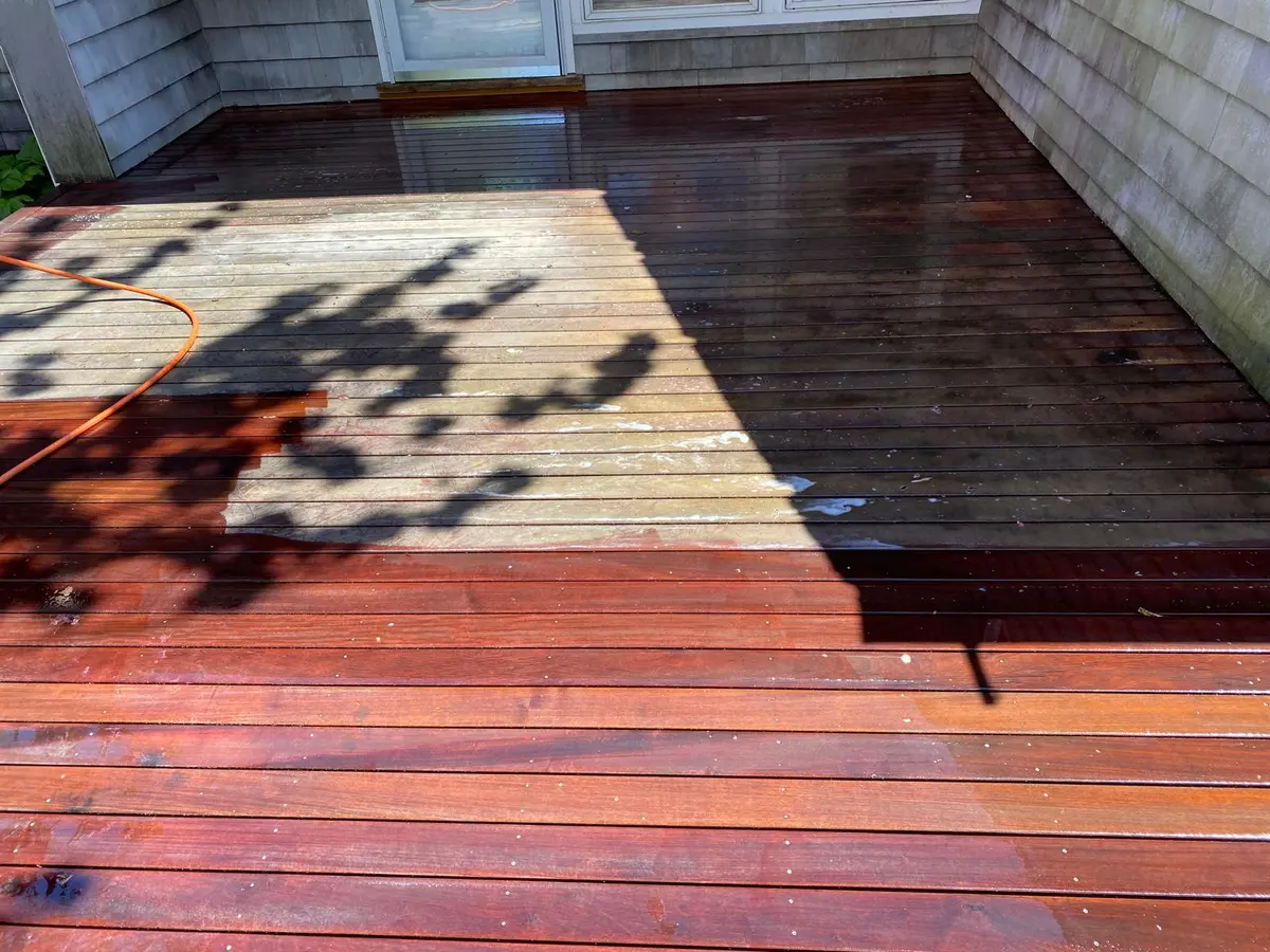 Deck mid-stain, showing the contrast between finished and raw wood