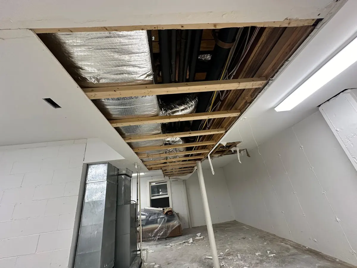 Ceiling opened up for drywall replacement, insulation exposed
