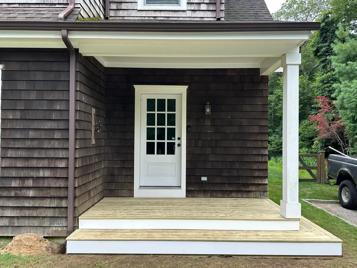 Finished deck and entry steps on a shingle-style home