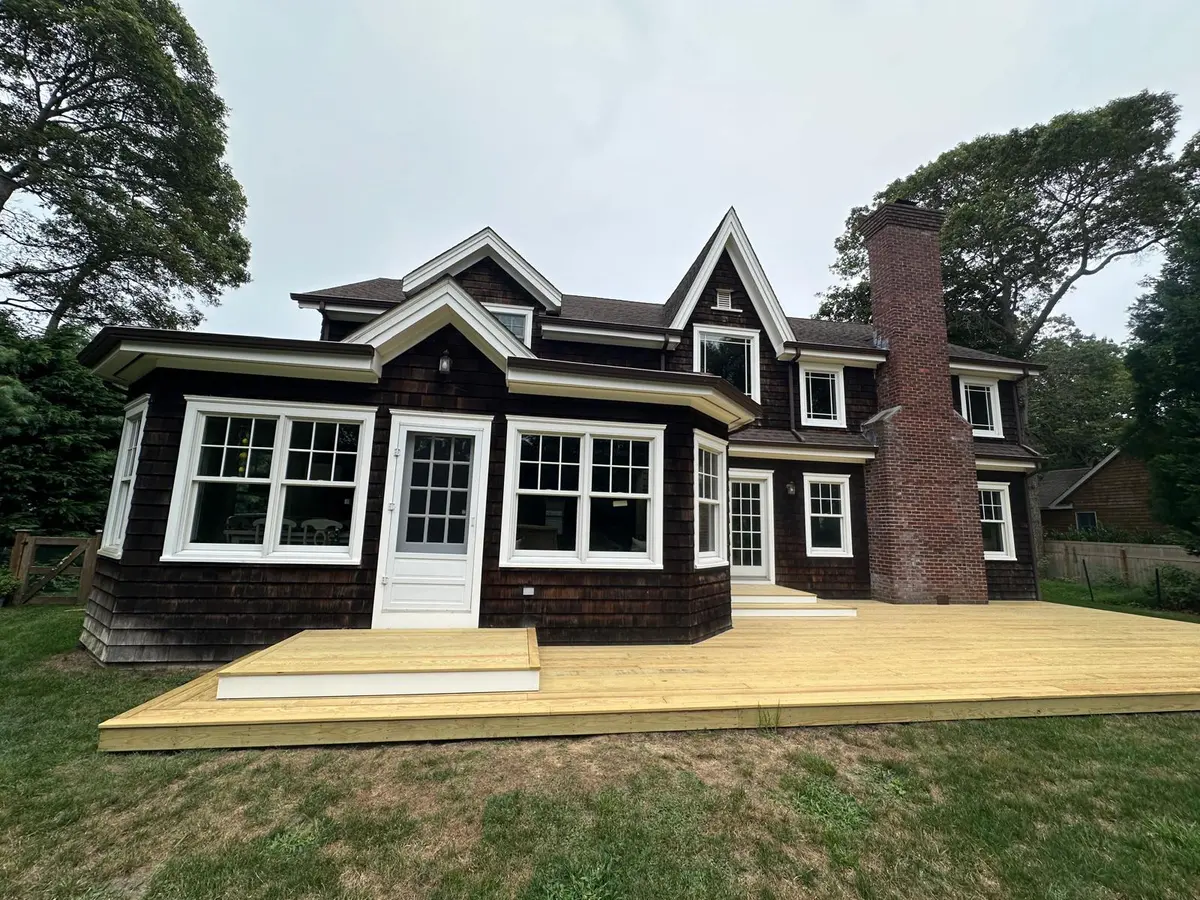 Dark navy-painted exterior with new deck addition