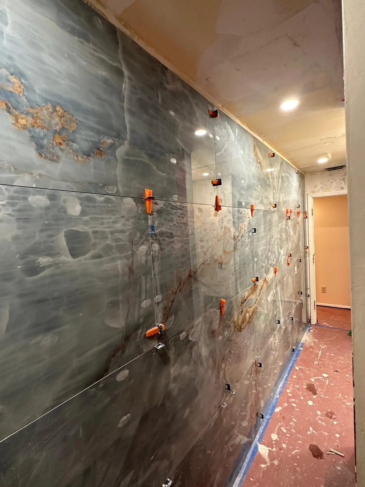 Marbled bathroom tile installation in progress
